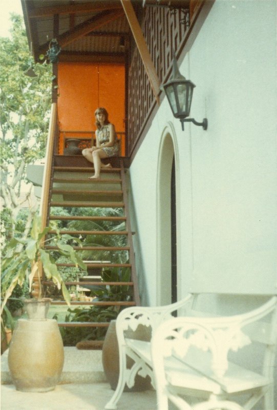 Linda sitting on the steps that lead up to the living room