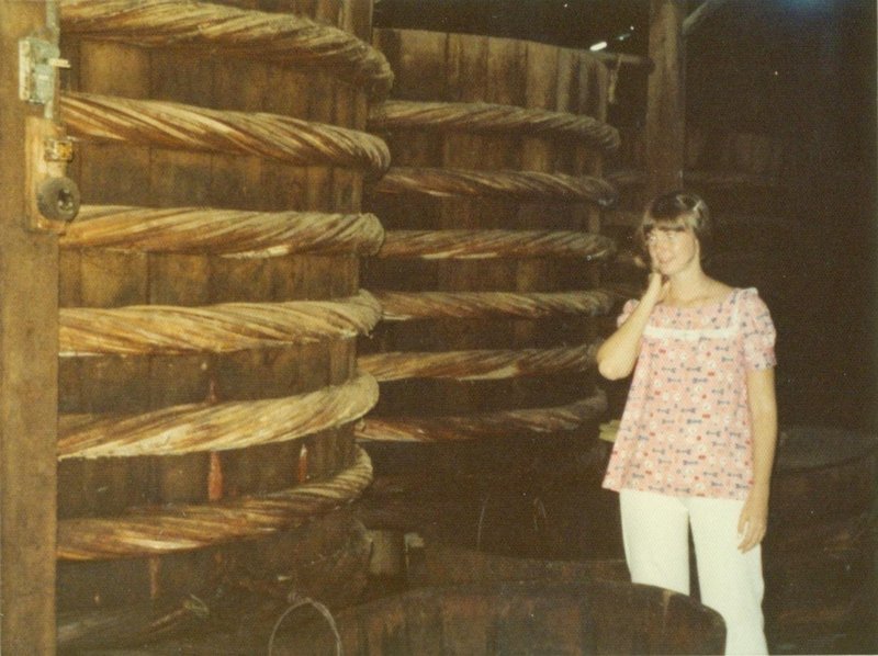 Linda next to vats full of layers of rotten fish and salt.  