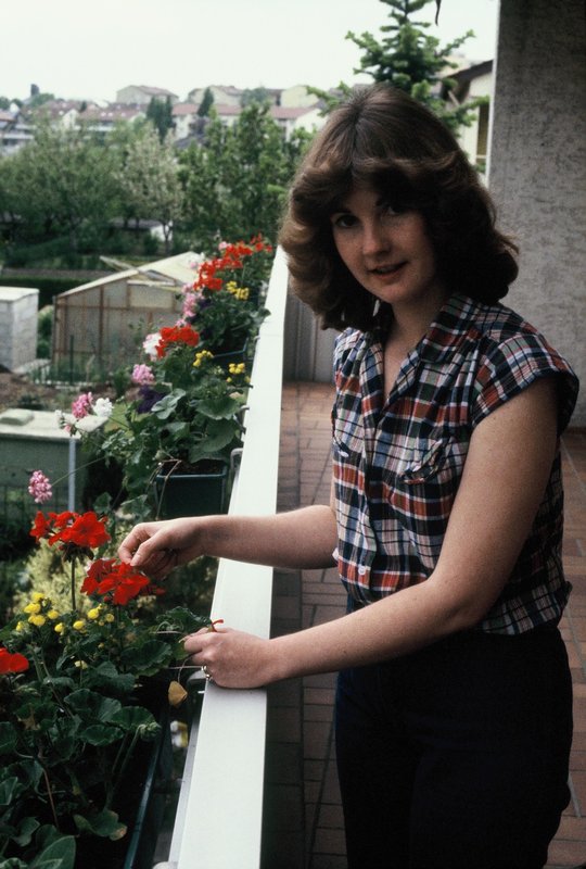 Linda gardening on our balcony