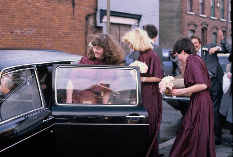 Bridesmaids entering the limo on the way to the church
