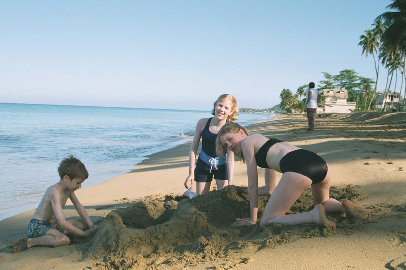 Will, Rosanna, and Tamara building sandcastles on Rincon Beach