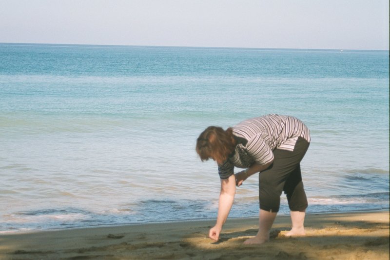 Linda finding a sea shell on Rincon Beach