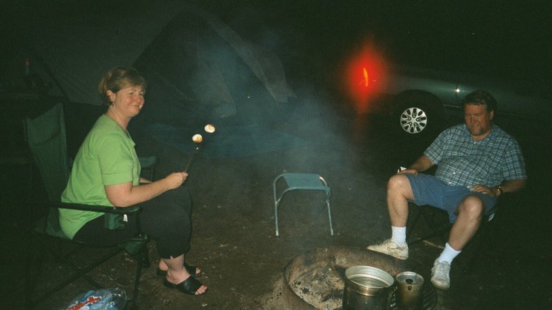 Linda and Bob sitting around the campfire