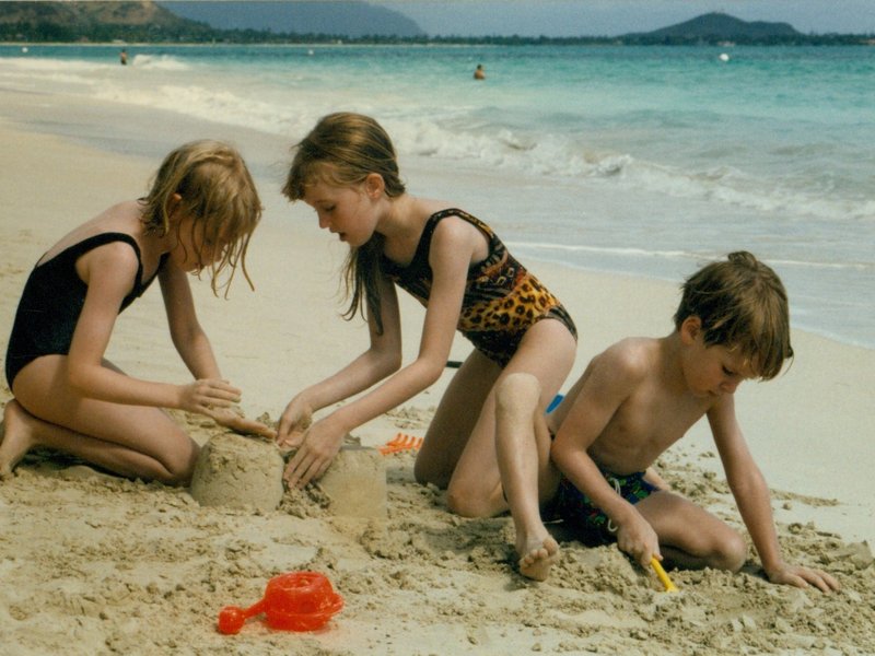 Rosanna, Tamara, and Will building sandcastles