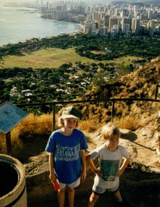 Rosanna and Will on top of Diamond Head with Honolulu in the background