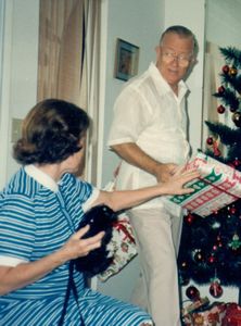 Mom handing a present to Dad