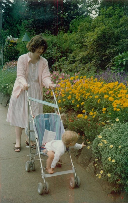 Linda pushing Will in his carriage at Butchart Gardens