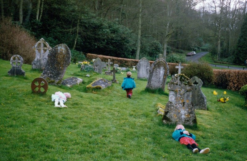 Kids playing dead at the churchyard of Lorne Doone's church