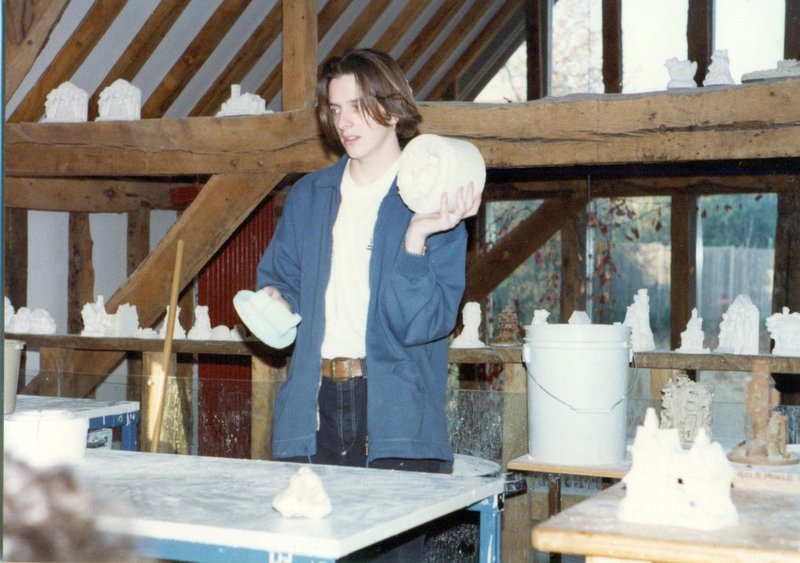 Craftsman explaining how to make cottages at John Hines Studios