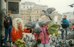 Rosanna, Tamara, and Will feeding pigeons at Traflagar Square