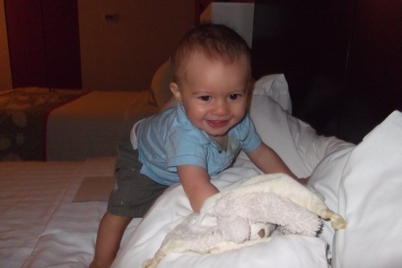 Liam enjoying the bed in our hotel
