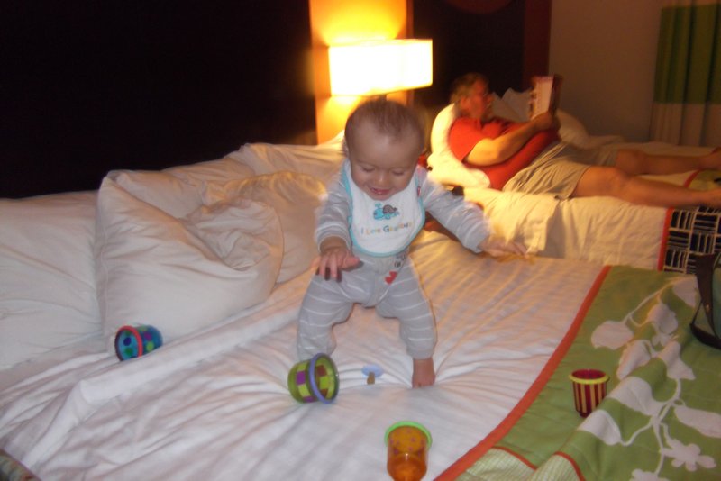 Liam enjoying the bed in our hotel