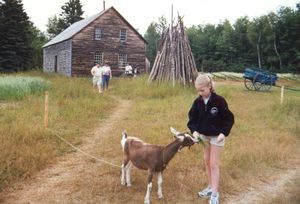 Rosanna feeding a goat at the Acadian Open Air Museum, Caraquet, New Brunswick