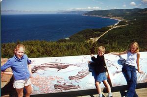 Rosanna, Will, and Tamara looking for whale information on the Cabot Trail