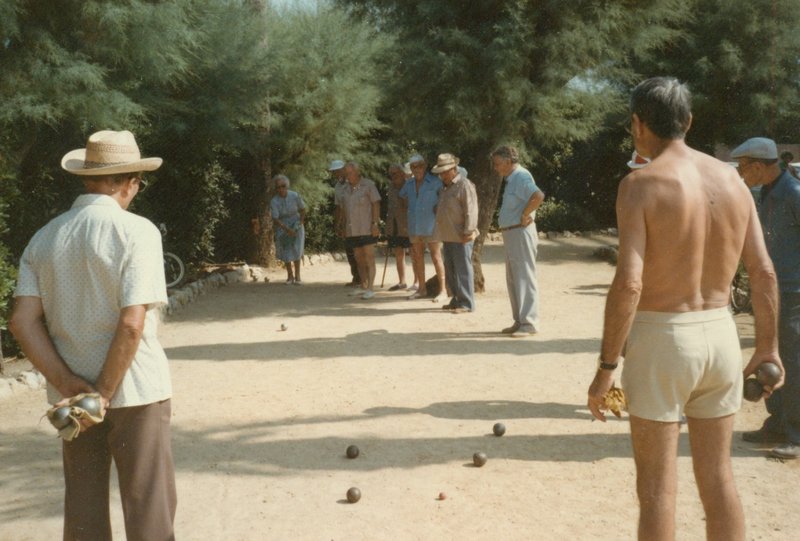 Men playing boules in the late afternoon