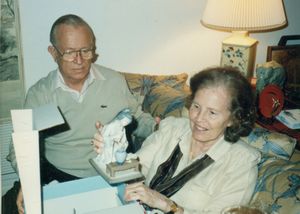 Dad and Mom opening CHristmas presents