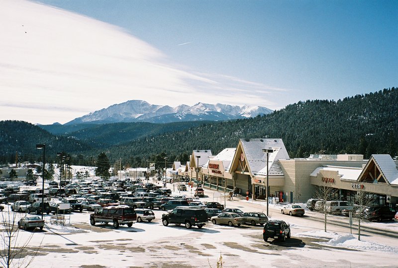 Plaza with our grocery store with Pikes Peak behind
