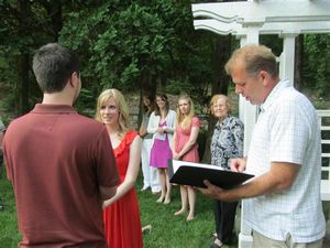 Evan and Rosanna exchanging vows at Rehersal while Steve officiates, bridesmaids look on - Copy