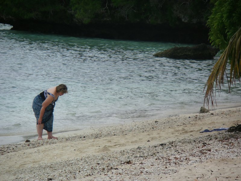 116 Linda looking for sea shells and coral on the beach at Lifou Island