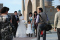 Wedding party posing for pictures at Registan Square in Samarkand