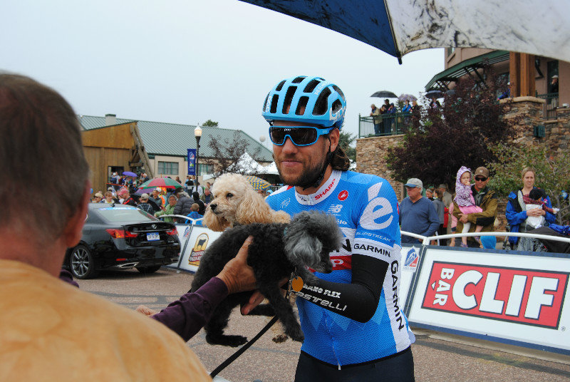 USA Pro Challenge - Thomas Dekker holding a spectator's dogs