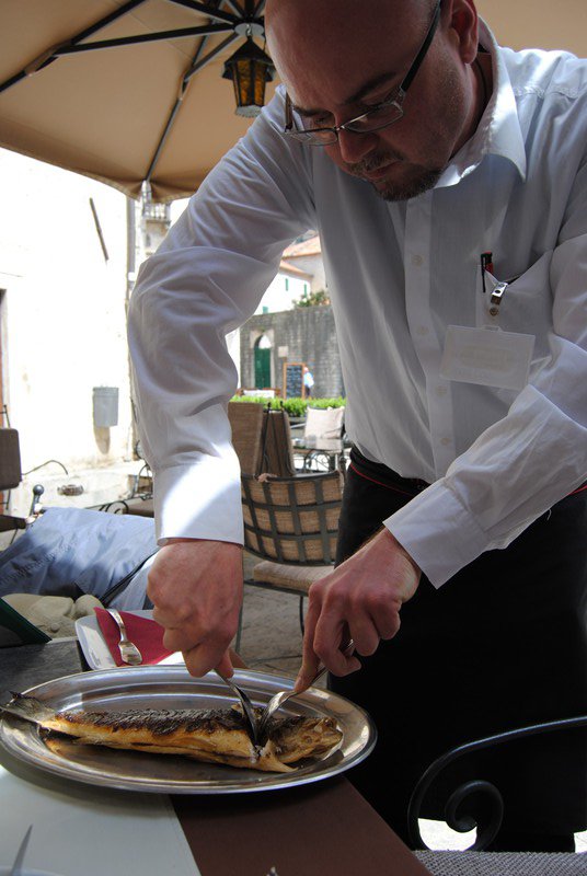 The waiter preparing our sea bass for lunch