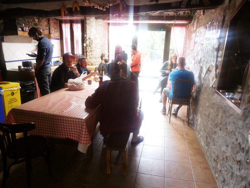 Pilgrims cooking and reading their emails in Albergue Cuatro Cantones in Belorado