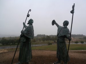 Statue of pilgrims on Monte do Gozo pointting to Santiago