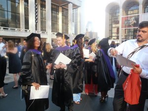 Classmates gather in Lincoln Center plaza following graduation