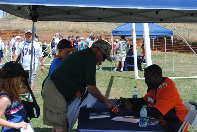 Fans getting autographs from Bronco player
