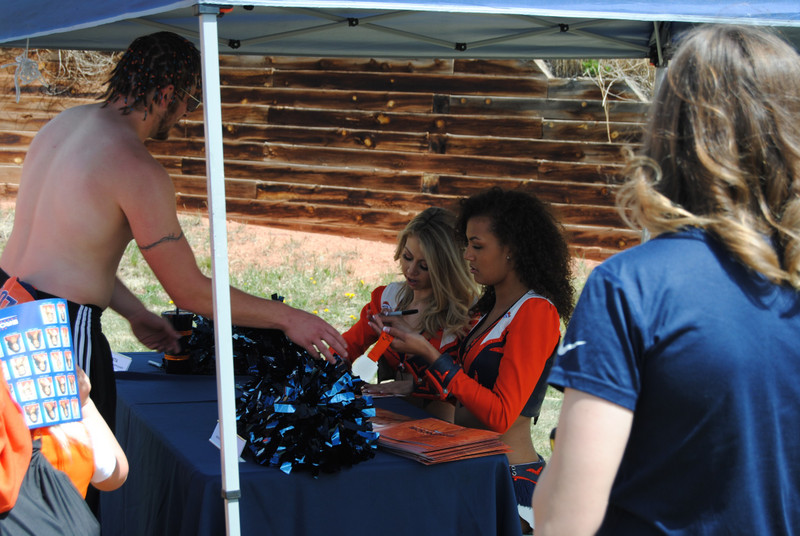 Fans getting autographs from Bronco cheerleaders