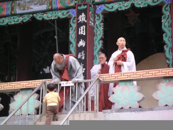 Monks play with kids