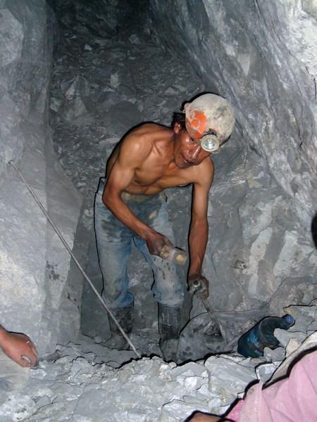 A miner “drilling” a hole for the dynamite.
