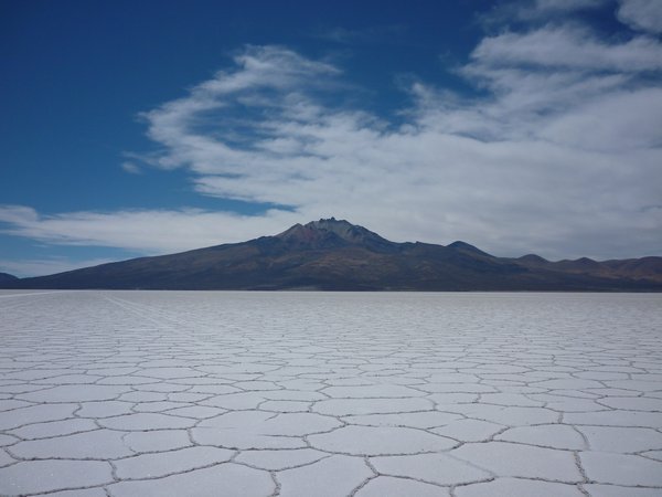 Salt flats with volcano in background