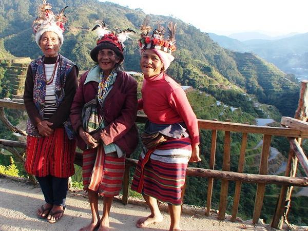 Ifugao women posing for the tourists in front of the rice terraces in Banaue