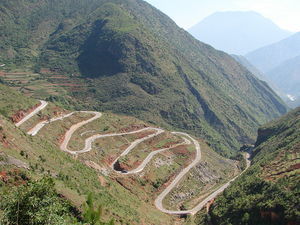  Road snakes down the mountainside, somewhere on the route between Lijiang and Lugu Lake