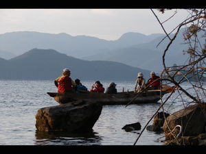Tourists on Lake Lugu just after sunrise