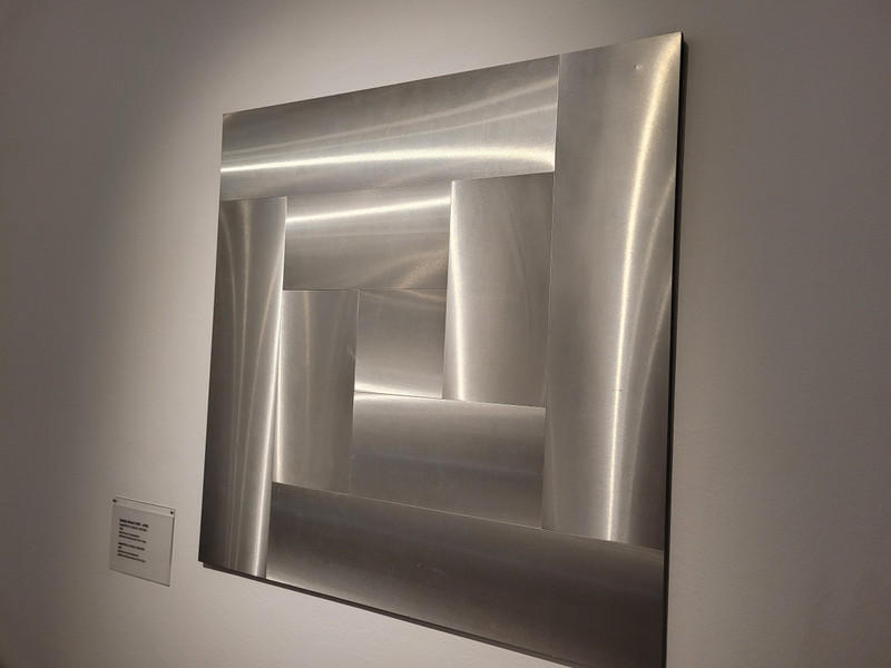 This exhibit is made up of flat pieces of metal that seem to move