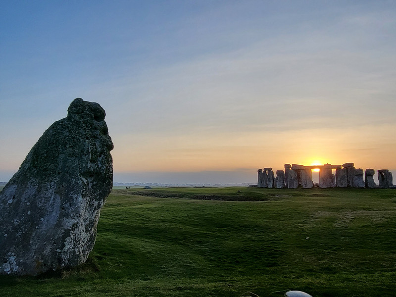 Sunset, the sun is between the stones marking the winter solstice