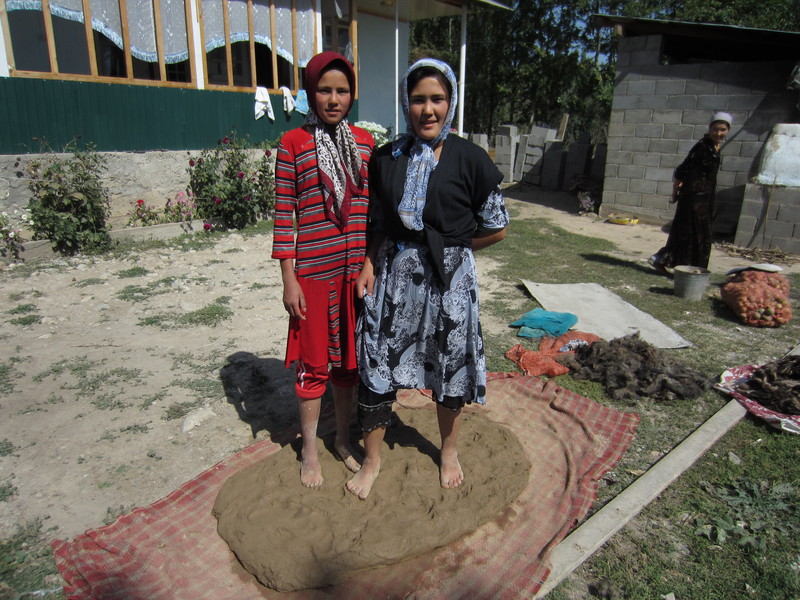 Latchin's daughters stomp mud and sheep wool to build new tandoor oven
