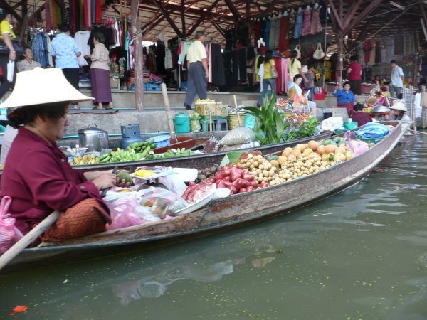 Lady selling fruits and vegetables at the Floating Market