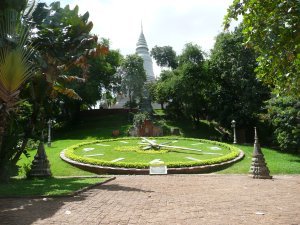 View looking up towards Wat Phnom with a lawn clock in the foreground