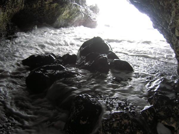 water crashing into a cave