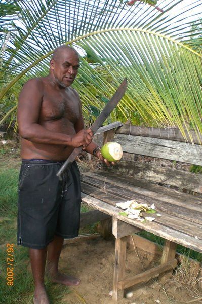 Our landlord opening coconuts