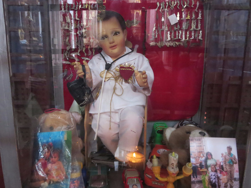 A baby Jesus doll dressed as a doctor