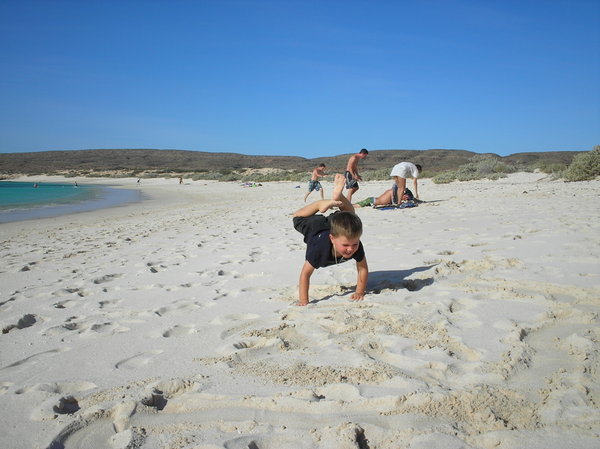 Axel trying to copy the guys next to us doing hand-stands