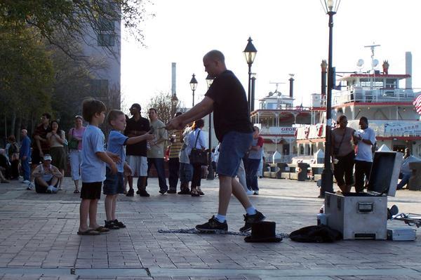 Street performers entertain the crowd on River Street