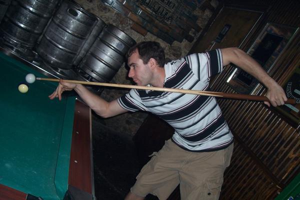Chris plays pool at one of the many bars along River Street