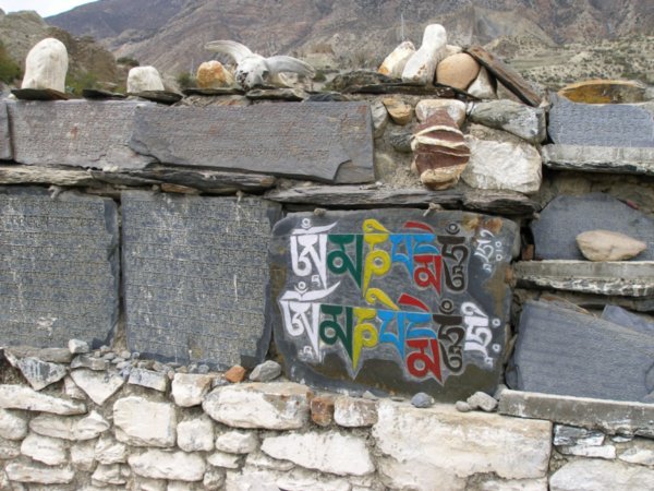 Stones enscribed with the mantra, north of Humde, Nepal