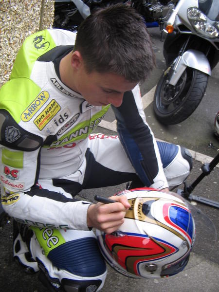James signs a helmet 